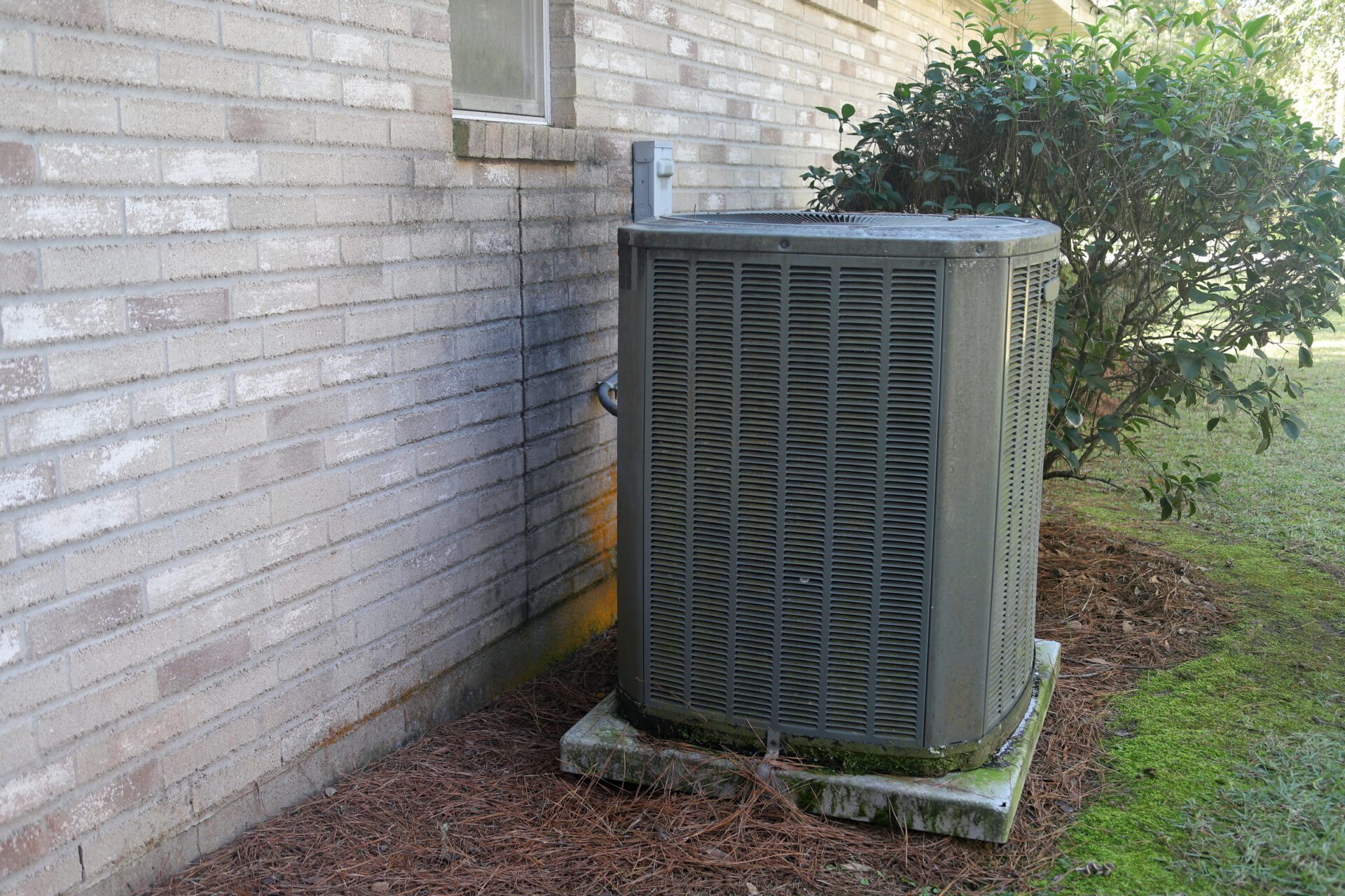 Air Conditioner Unit next to brick home Air Conditioner Unit next to brick home