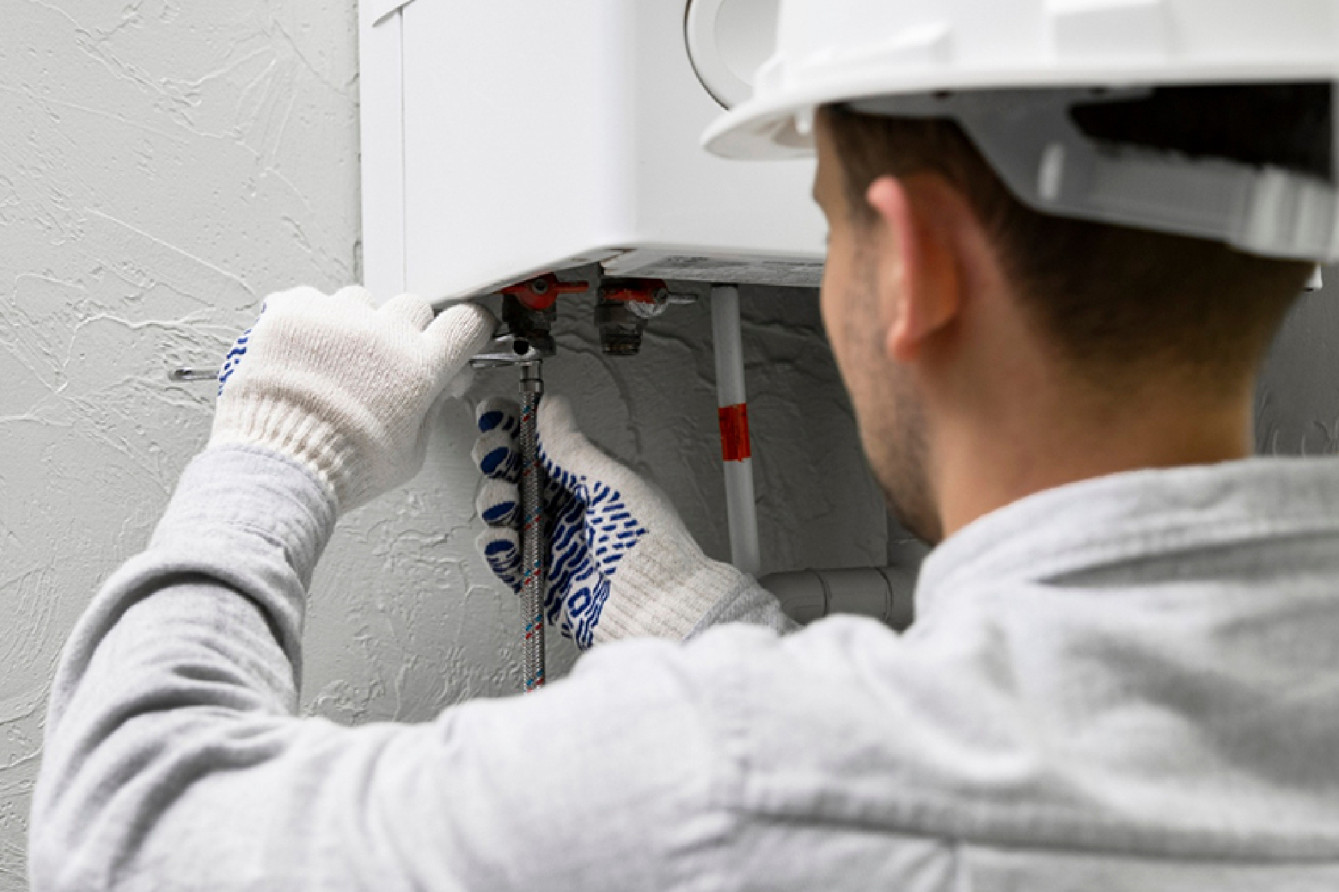 worker repairing water heater worker repairing water heater