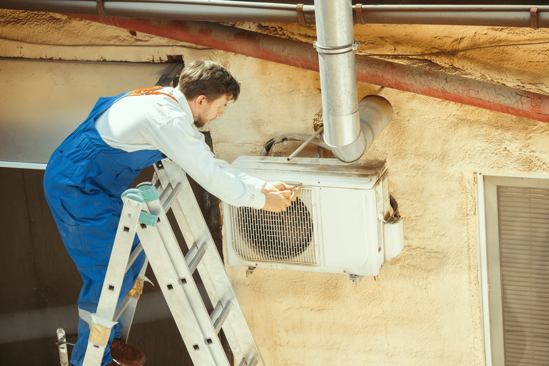 hvac technician working on a capacitor part for condensing unit. male worker or repairman in uniform repairing hvac technician working on a capacitor part for condensing unit. male worker or repairman in uniform repairing