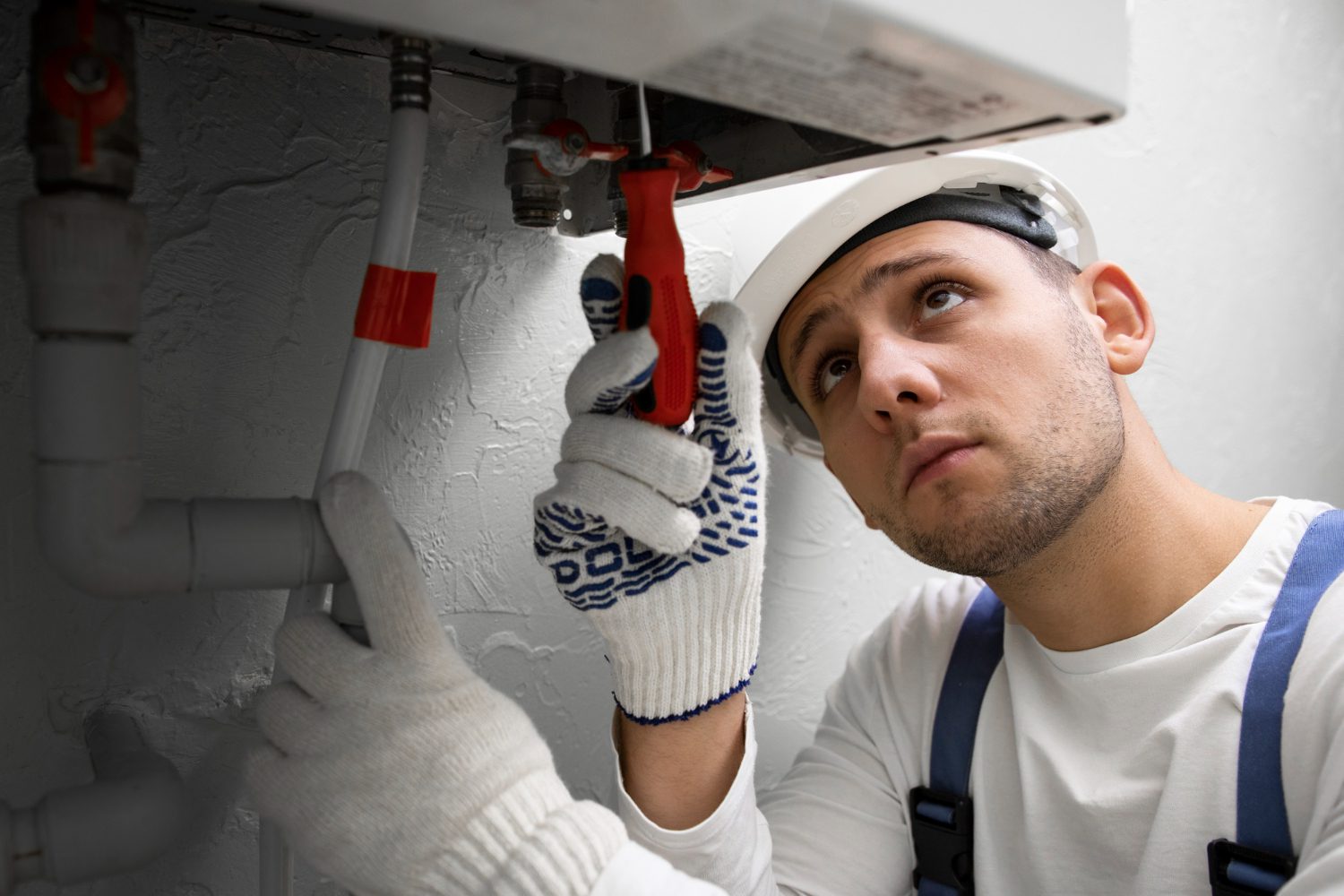 worker-repairing-water-heater worker-repairing-water-heater